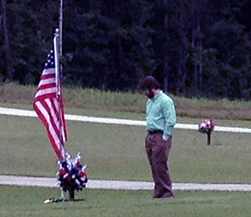 John Alderman, who was captain of Mike's cavalry troop in Iraq, at the grave Thursday.